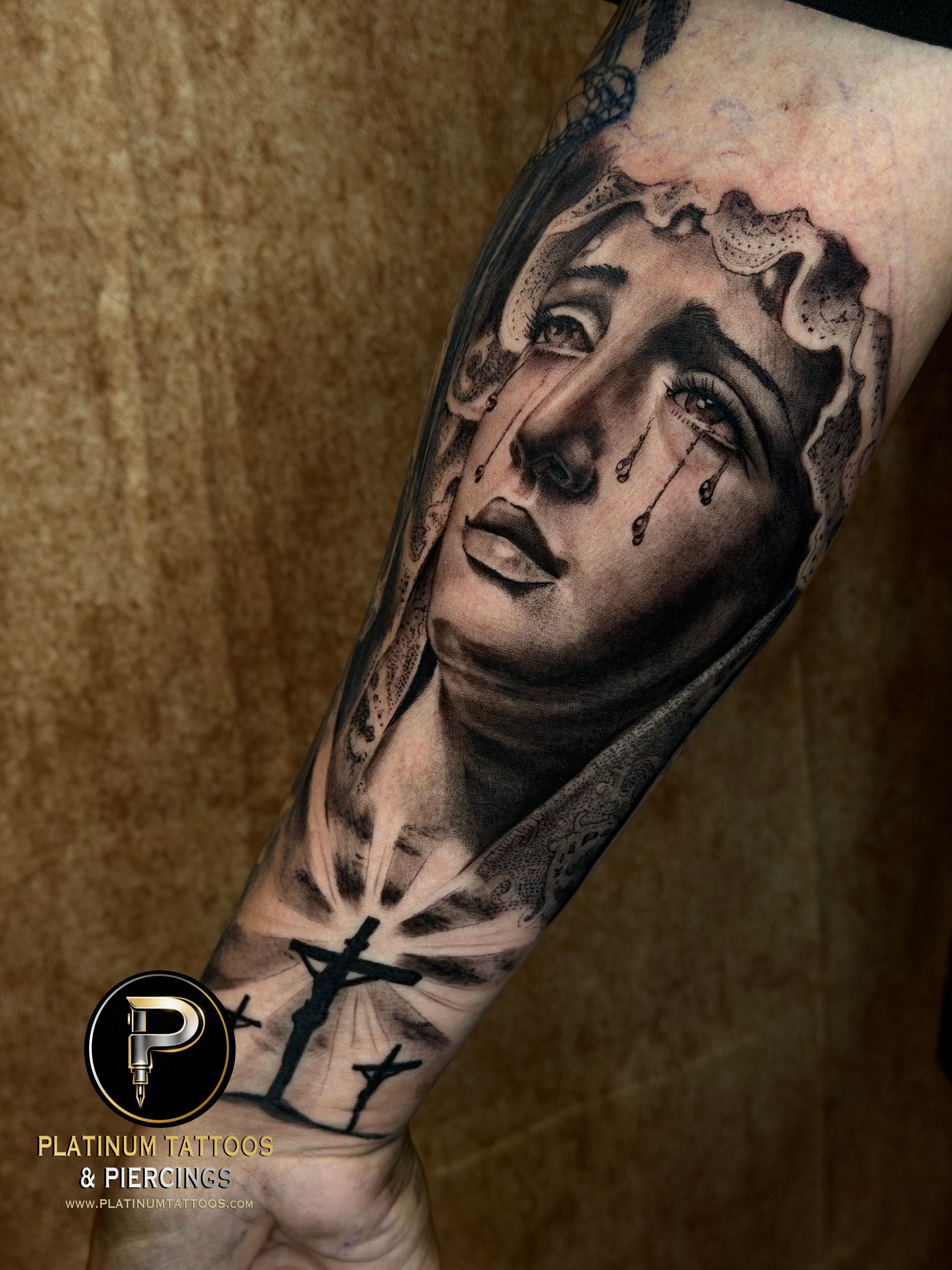 Black & Grey Black Cross, Virgen tattoo on the Forearm by Jerson at Platinum Tattoos & Piercings, San Antonio TX
