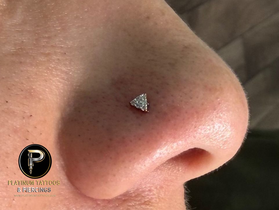 Nostril piercing with 14k Yellow Gold Threadless by Buddha Jewelry by Mingo at Platinum Tattoos & Piercings, San Antonio TX