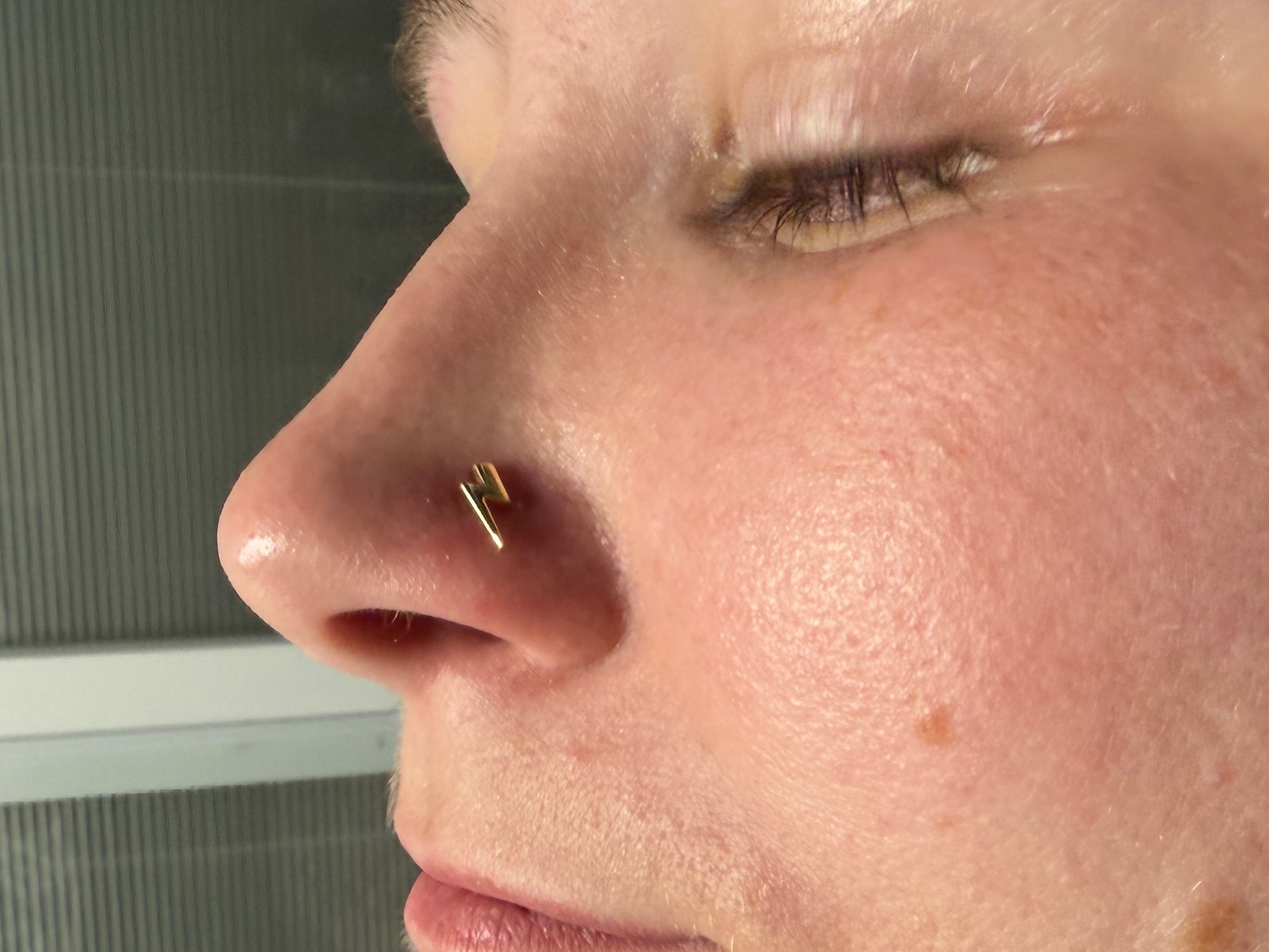 Nostril piercing with 14k Yellow Gold Threadless by Anatometal by Mingo at Platinum Tattoos & Piercings, San Antonio TX