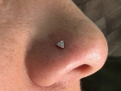 Nostril piercing with 14k Yellow Gold Threadless by Buddha Jewelry by Mingo at Platinum Tattoos & Piercings, San Antonio TX
