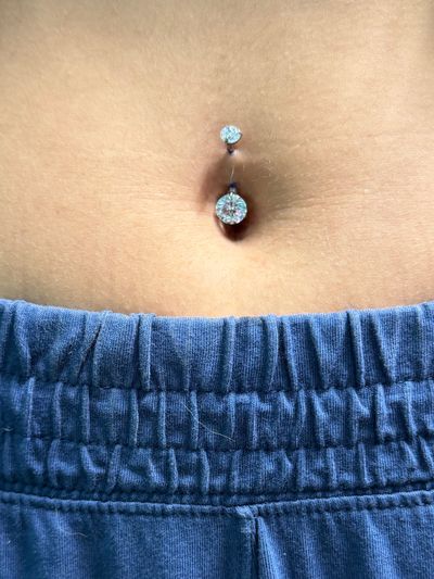 Belly Button piercing with Implant Grade Titanium Curved Barbell by Other by Mingo at Platinum Tattoos & Piercings, San Antonio TX