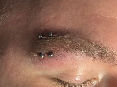 Eyebrow piercing with Implant Grade Titanium Curved Barbell by Other by Mingo at Platinum Tattoos & Piercings, San Antonio TX