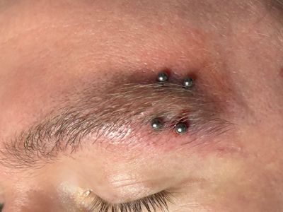 Eyebrow piercing with Implant Grade Titanium Curved Barbell by Other by Mingo at Platinum Tattoos & Piercings, San Antonio TX