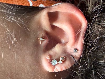 Tragus piercing with 14k Yellow Gold Threadless by Junipurr by Mingo at Platinum Tattoos & Piercings, San Antonio TX