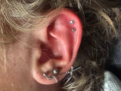 Curated ear piercing setup — 1st Helix, 2nd Helix with Implant Grade Titanium Disc by NeoMetal by Mingo at Platinum Tattoos & Piercings, San Antonio TX