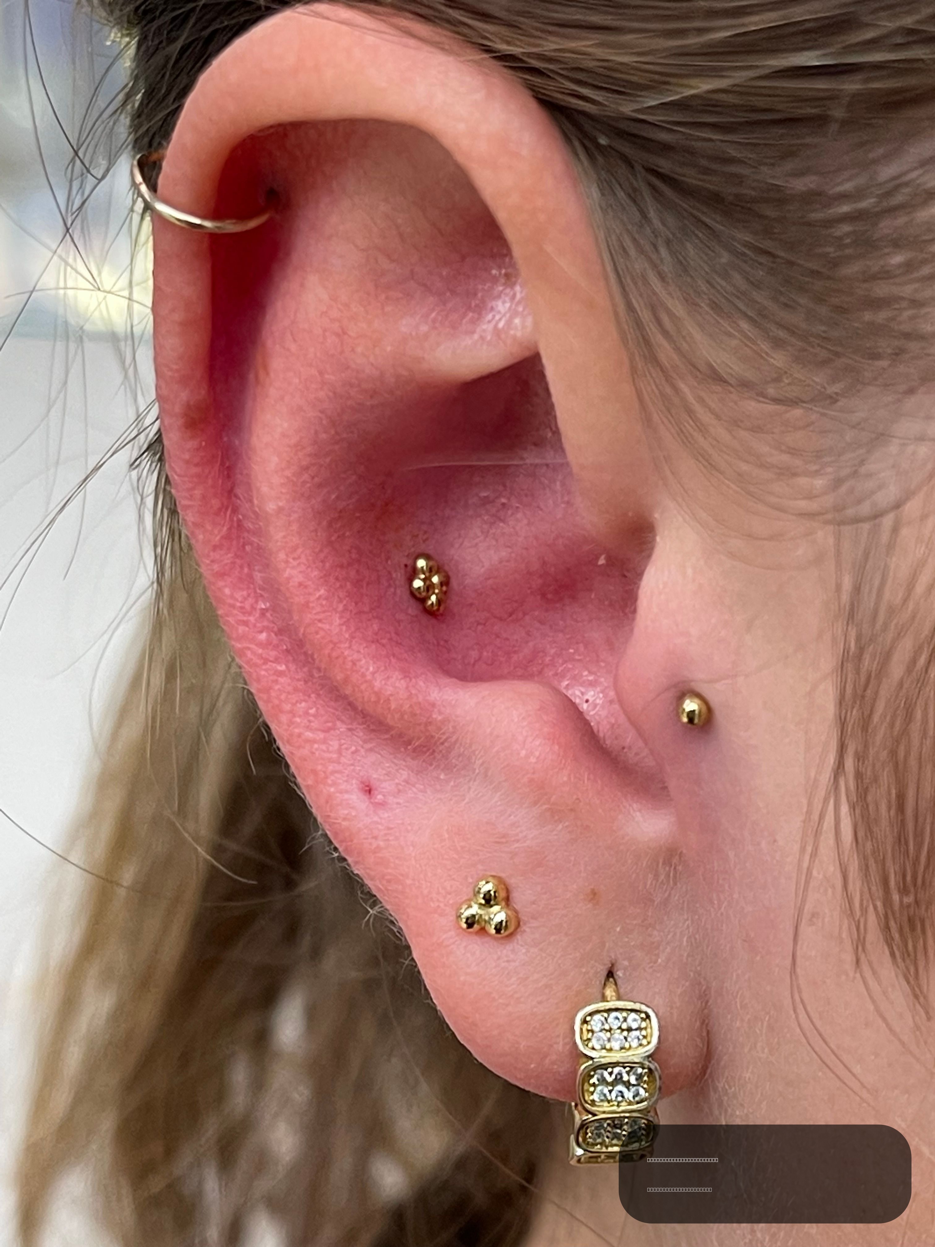 Conch piercing with 14k Yellow Gold Threadless by NeoMetal by Crystal at Platinum Tattoos & Piercings, San Antonio TX