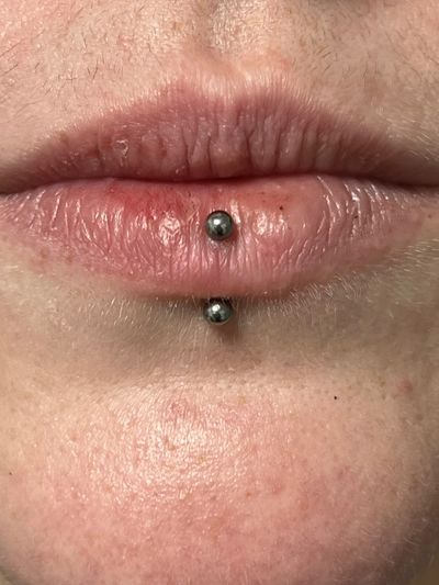 Vertical Labret piercing with Implant Grade Titanium Curved Barbell by Other by Harley at Platinum Tattoos & Piercings, San Antonio TX