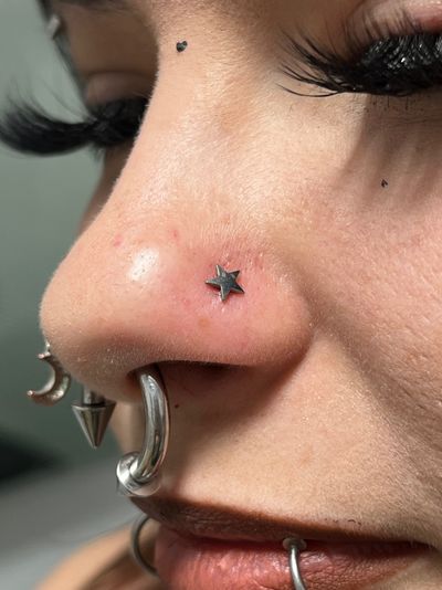 Nostril piercing with Implant Grade Titanium Star by NeoMetal by Harley at Platinum Body Piercings, San Antonio TX