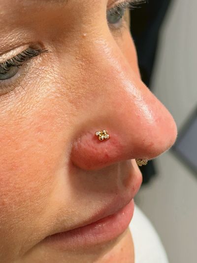 Nostril piercing with 14k Yellow Gold Labret Stud/Flat Back by Tawapa by Crystal at Platinum Body Piercings, San Antonio TX