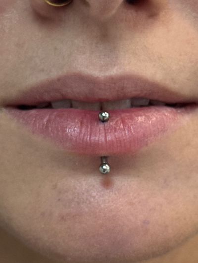 Vertical Labret piercing with Implant Grade Titanium Curved Barbell by NeoMetal by Crystal at Platinum Body Piercings, San Antonio TX