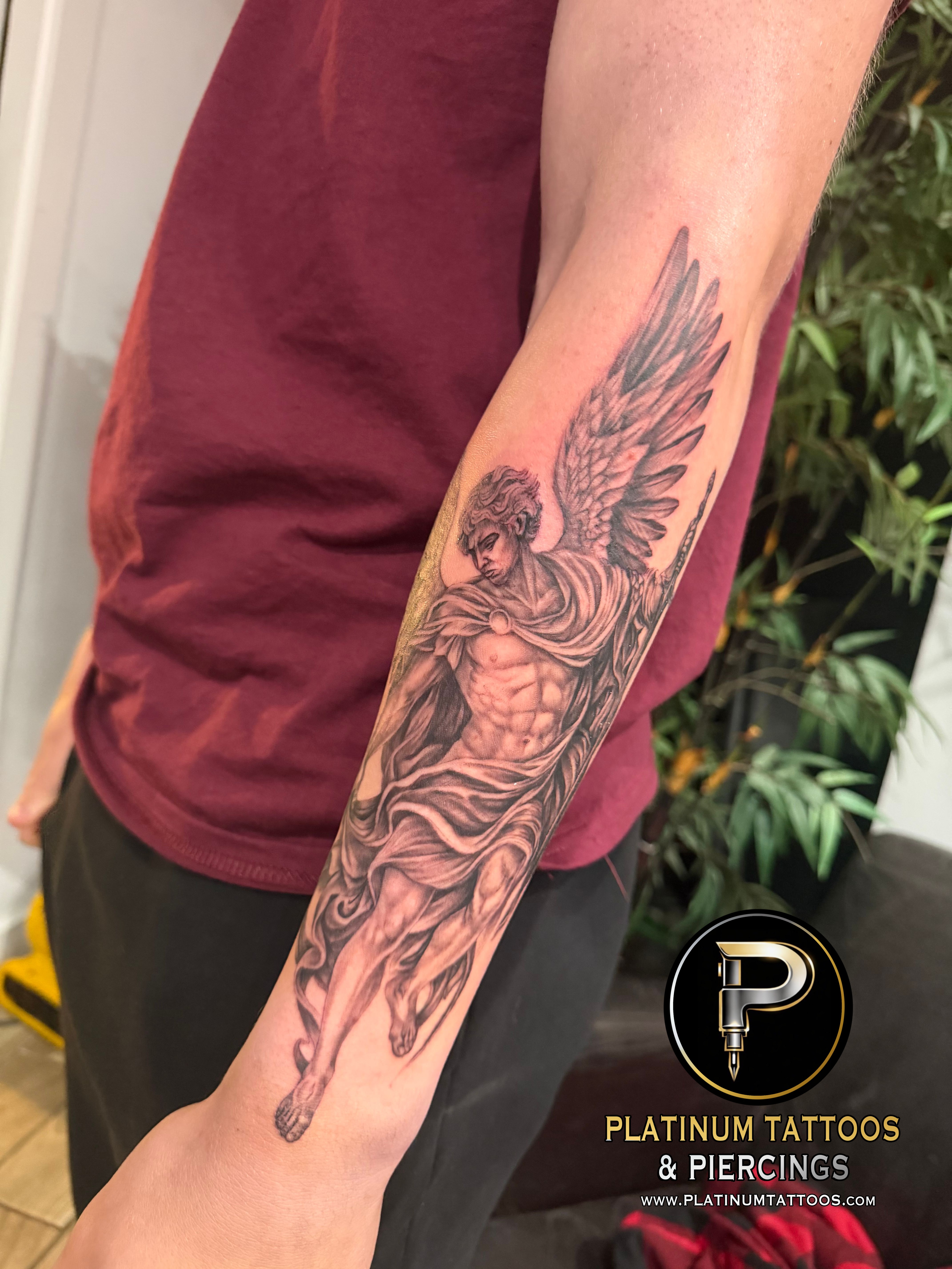 Black & Grey, Realism Black, Grey Sword, Angel tattoo on the Forearm at Platinum Tattoos & Piercings, San Antonio TX