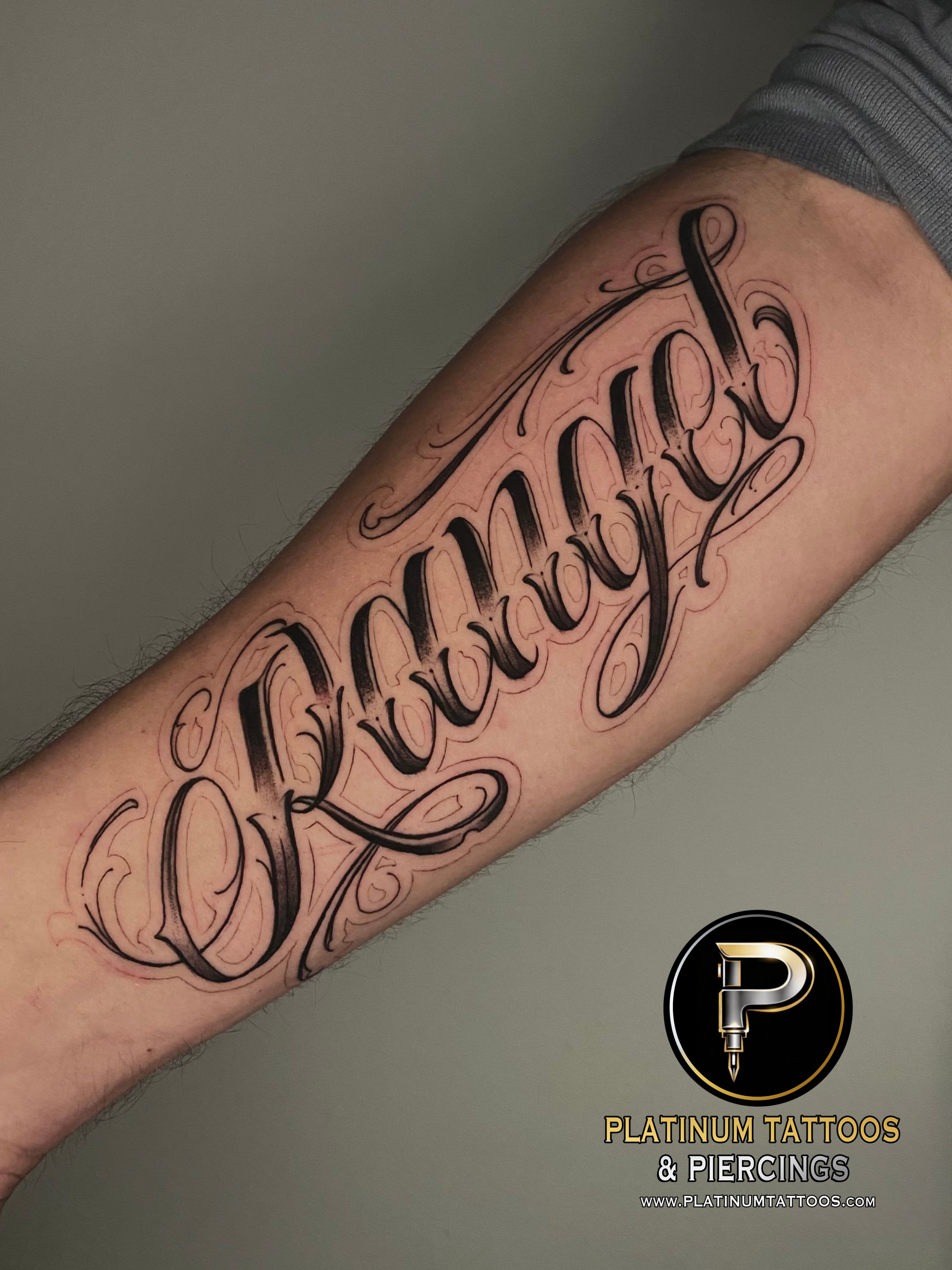 Lettering tattoo on the forearm by Remy at Platinum Tattoos & Piercings, San Antonio TX