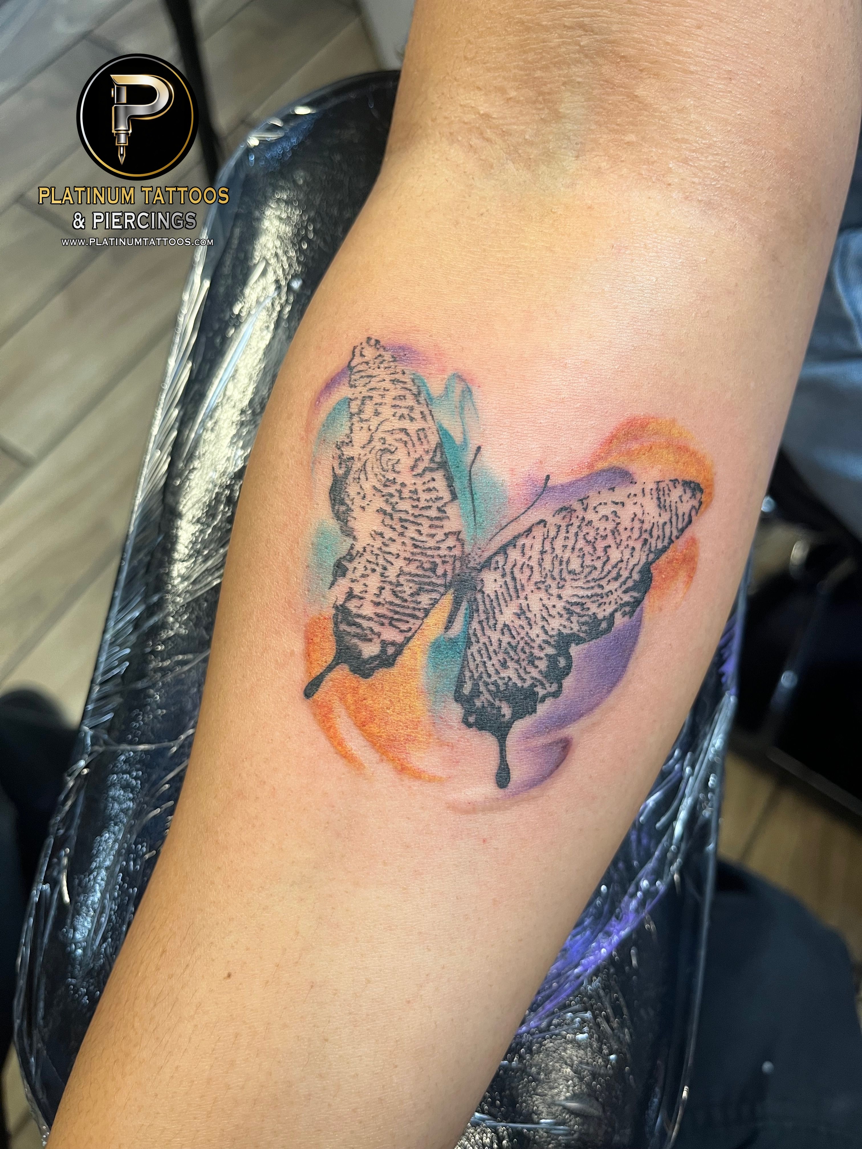 Watercolor tattoo on the forearm at Platinum Tattoos & Piercings, San Antonio TX