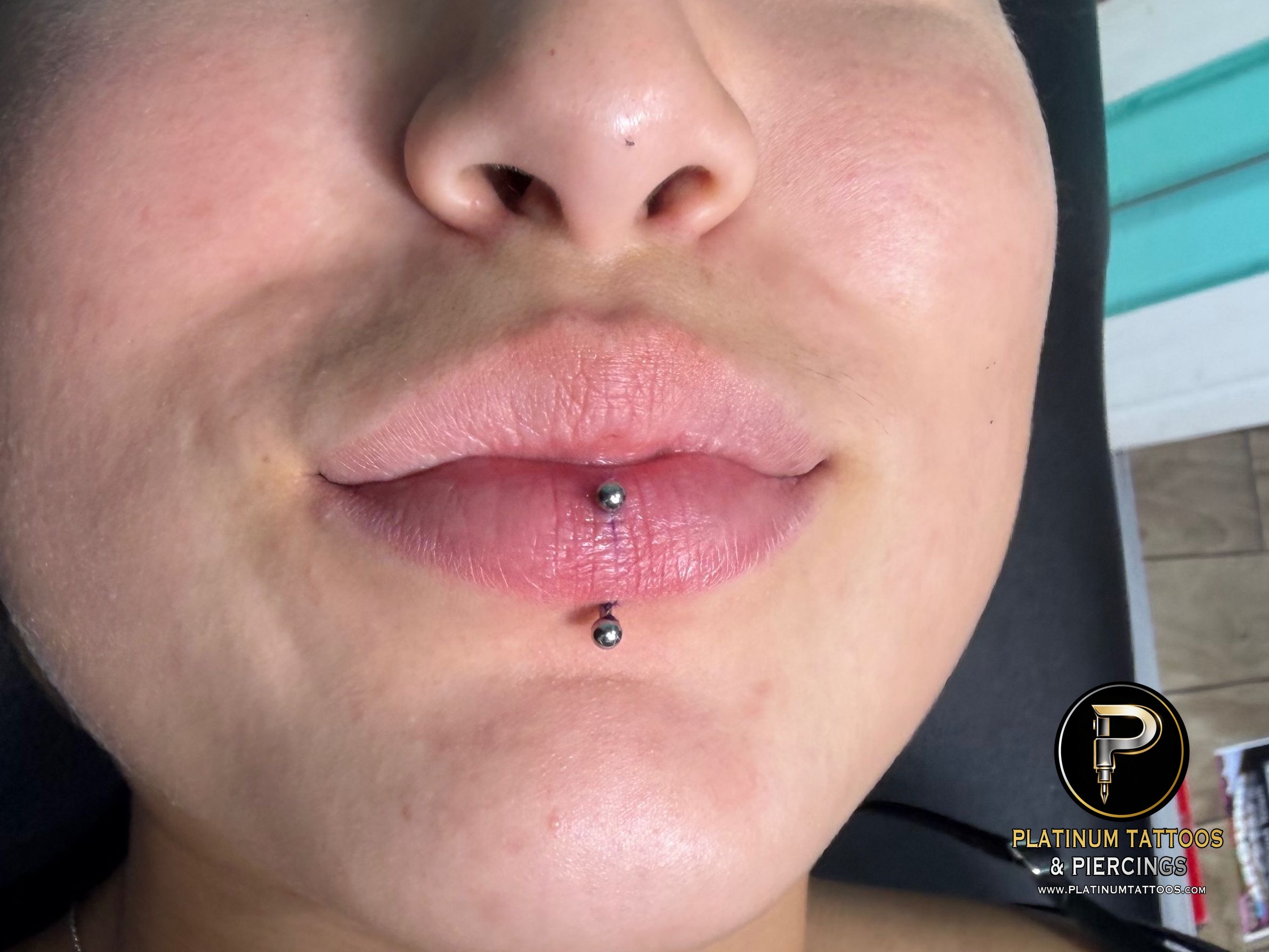 Curved Barbell piercing on the Vertical Labret by Mingo at Platinum Tattoos & Piercings, San Antonio TX