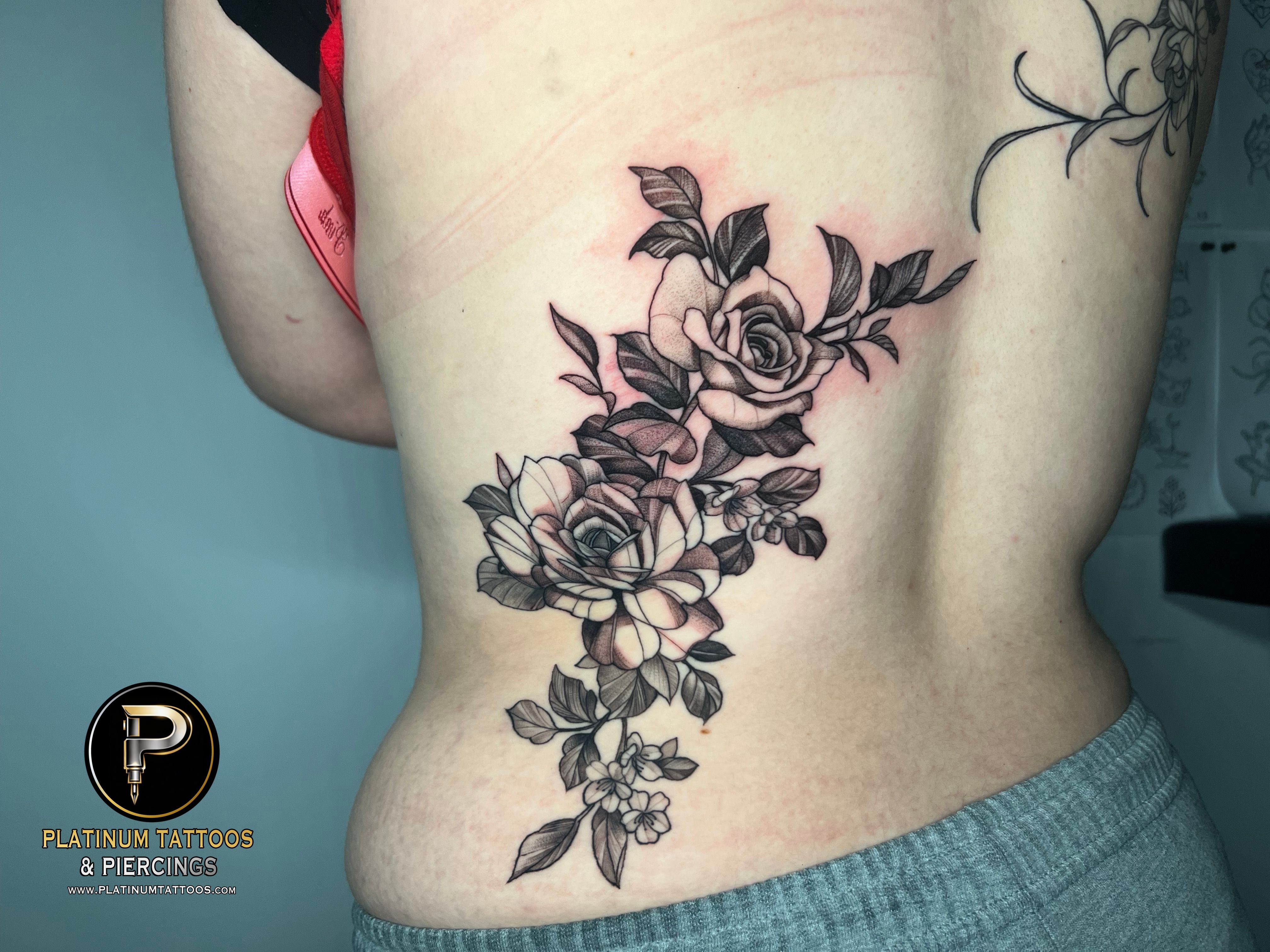Floral & Black & Grey & Dotwork tattoo on the lower back by Jesus at Platinum Tattoos Piercings, San Antonio TX