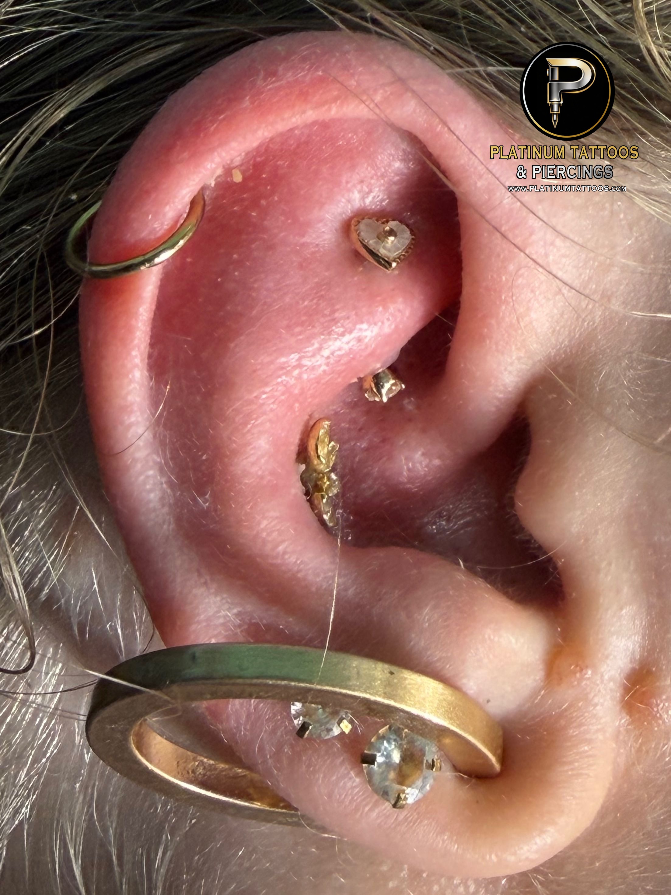Rook piercing with 14k Yellow Gold Curved Barbell by Buddha Jewelry by Mingo at Platinum Tattoos & Piercings, San Antonio TX