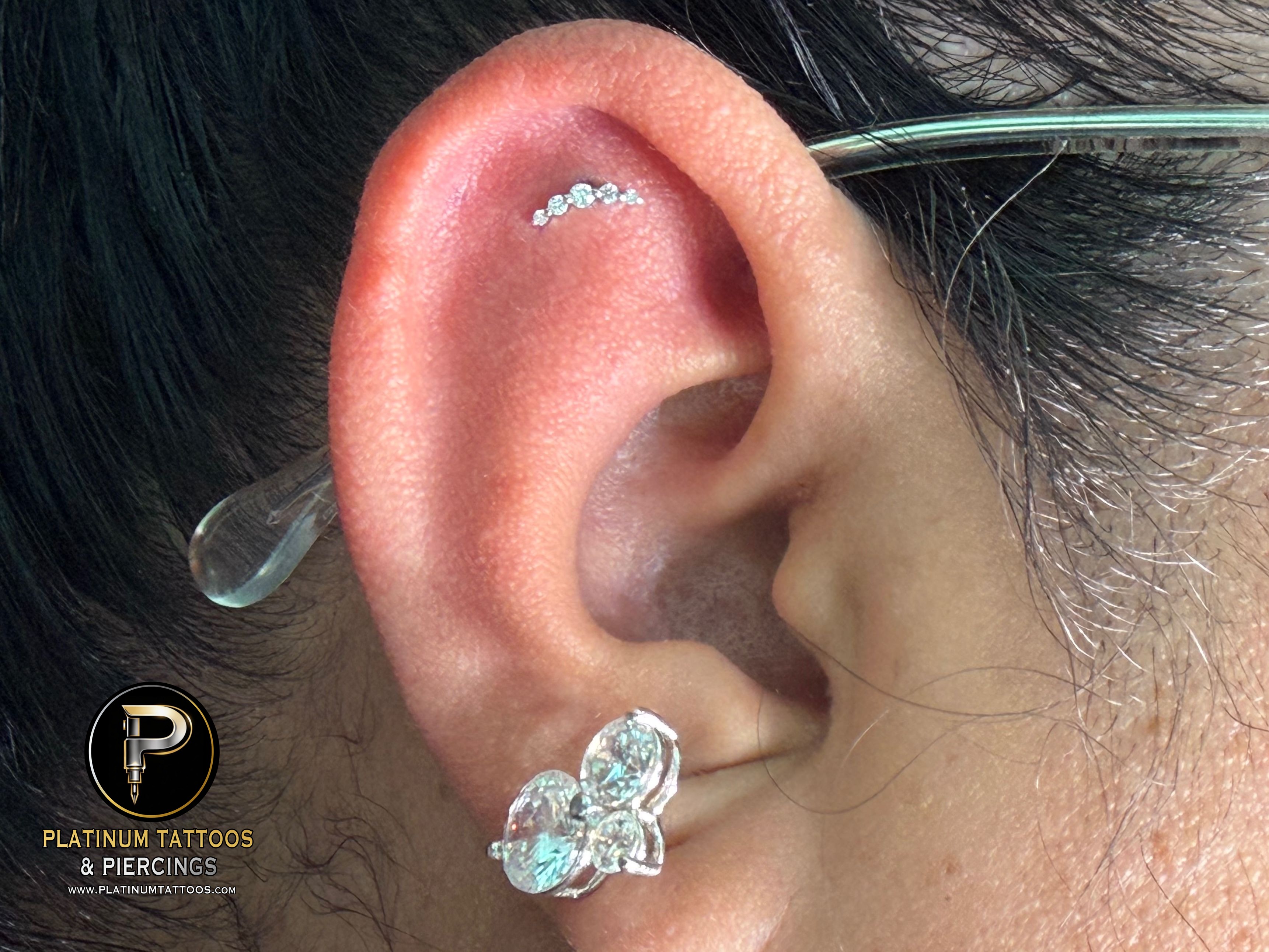 Flat piercing with 14k White Gold Cluster/Multi-Gem by Buddha Jewelry by Mingo at Platinum Tattoos & Piercings, San Antonio TX