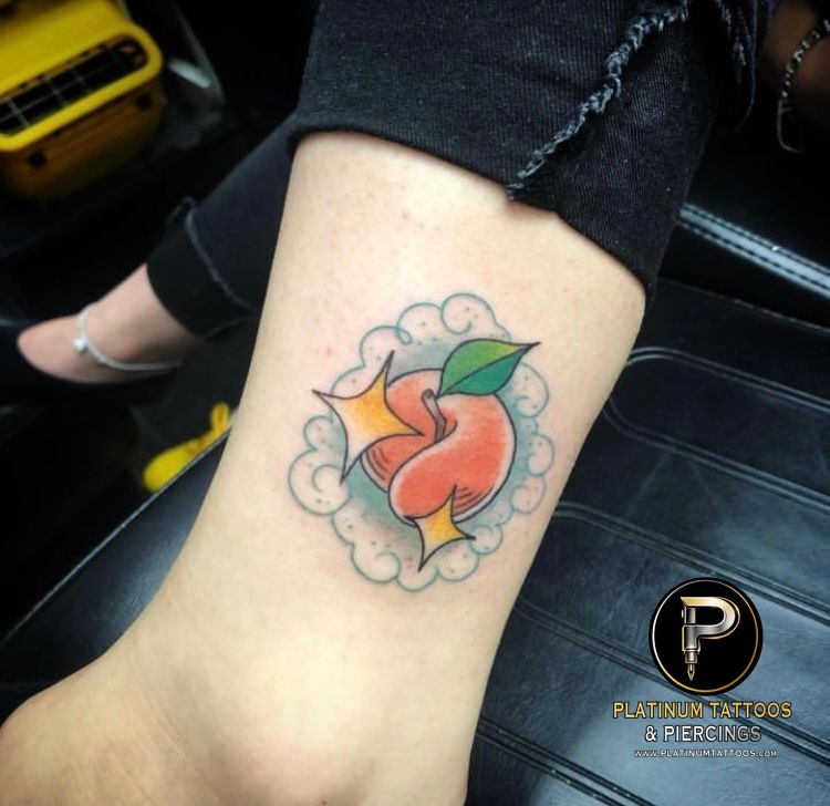 Color, Illustrative Orange, Green, Yellow, Blue Peach tattoo on the Ankle at Platinum Tattoos & Piercings, San Antonio TX