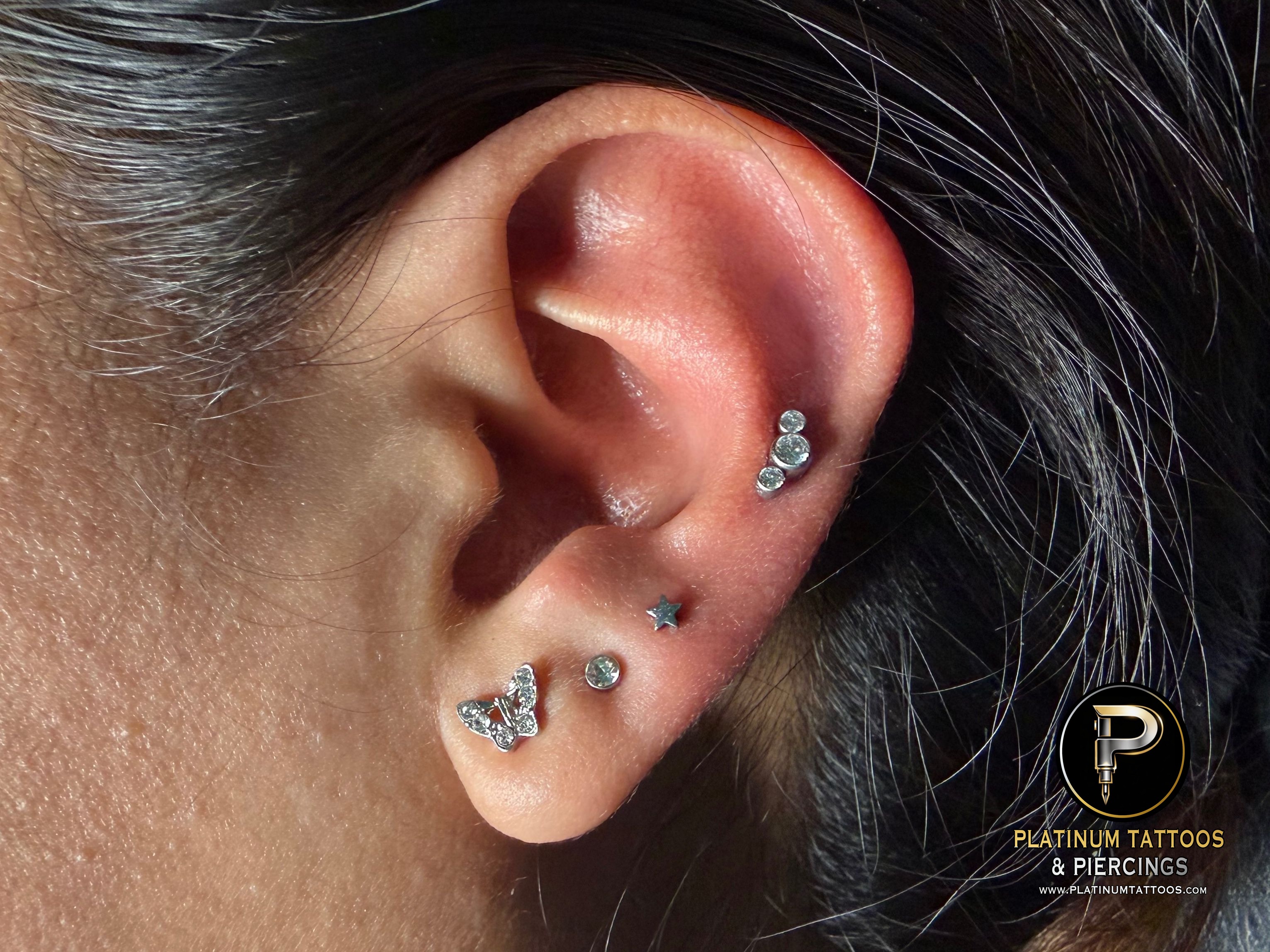 Curated ear piercing setup โ 3rd Lobe, 1st Helix with Implant Grade Titanium Star, Cluster/Multi-Gem by NeoMetal by Mingo at Platinum Tattoos & Piercings, San Antonio TX