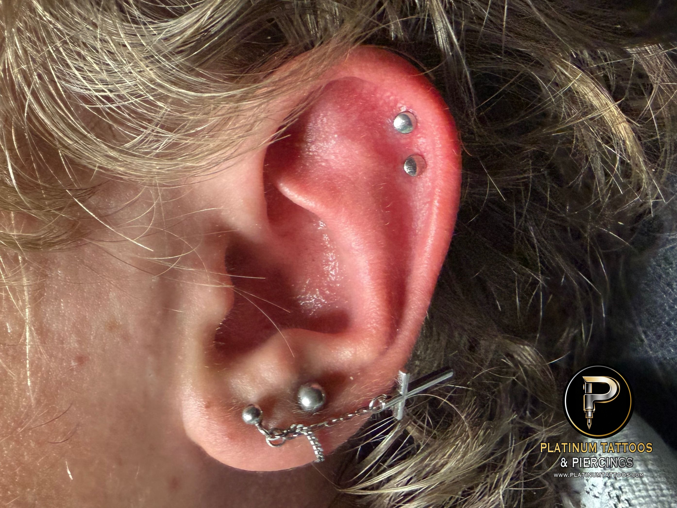 Curated ear piercing setup โ 1st Helix, 2nd Helix with Implant Grade Titanium Disc by NeoMetal by Mingo at Platinum Tattoos & Piercings, San Antonio TX