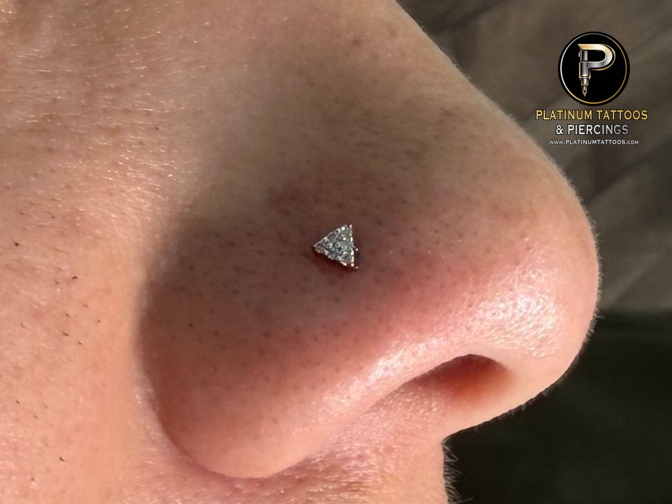 Nostril piercing with 14k Yellow Gold Threadless by Buddha Jewelry by Mingo at Platinum Tattoos & Piercings, San Antonio TX
