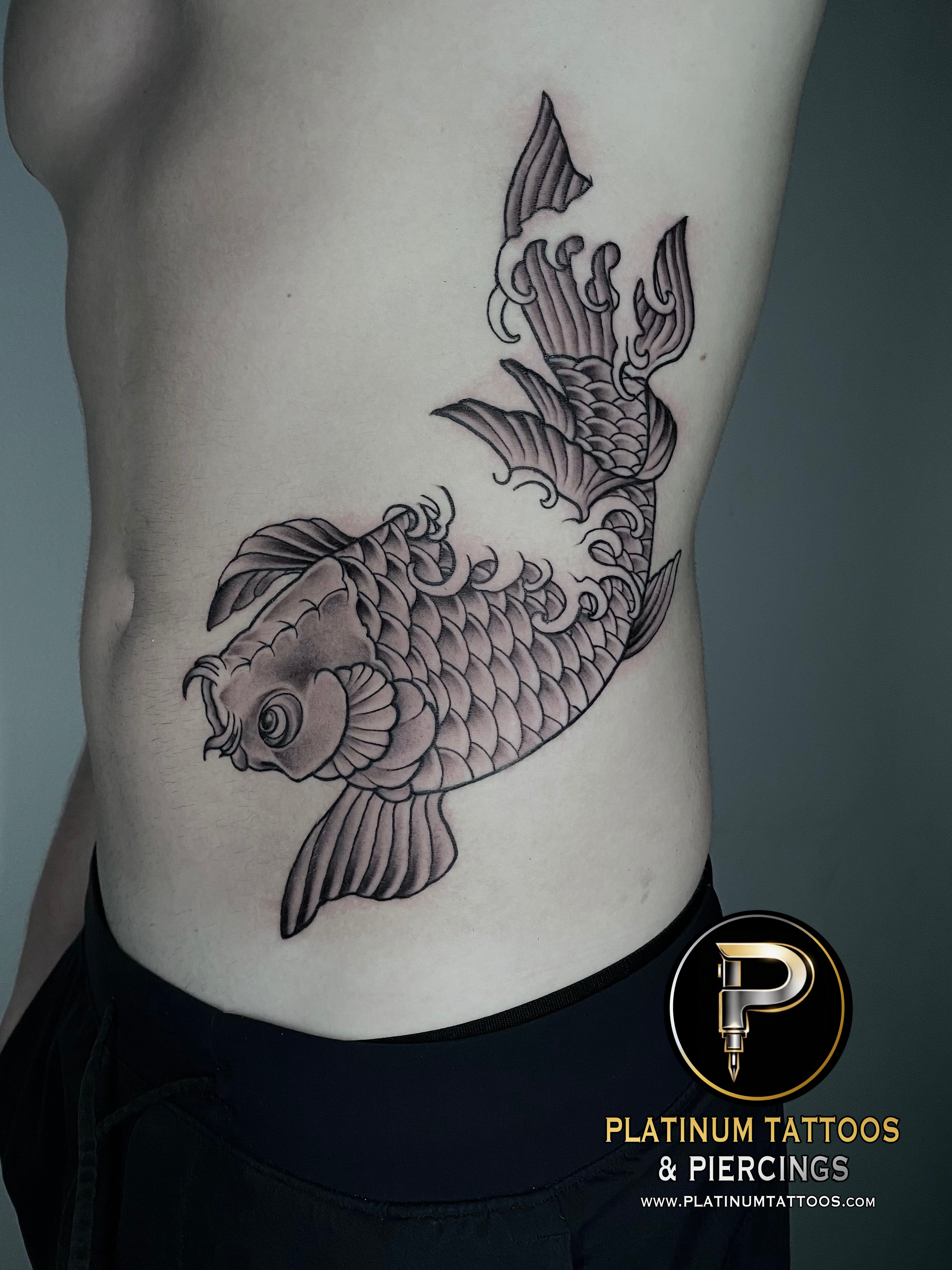 Japanese Black Fish tattoo on the Ribs by Remy at Platinum Tattoos & Piercings, San Antonio TX