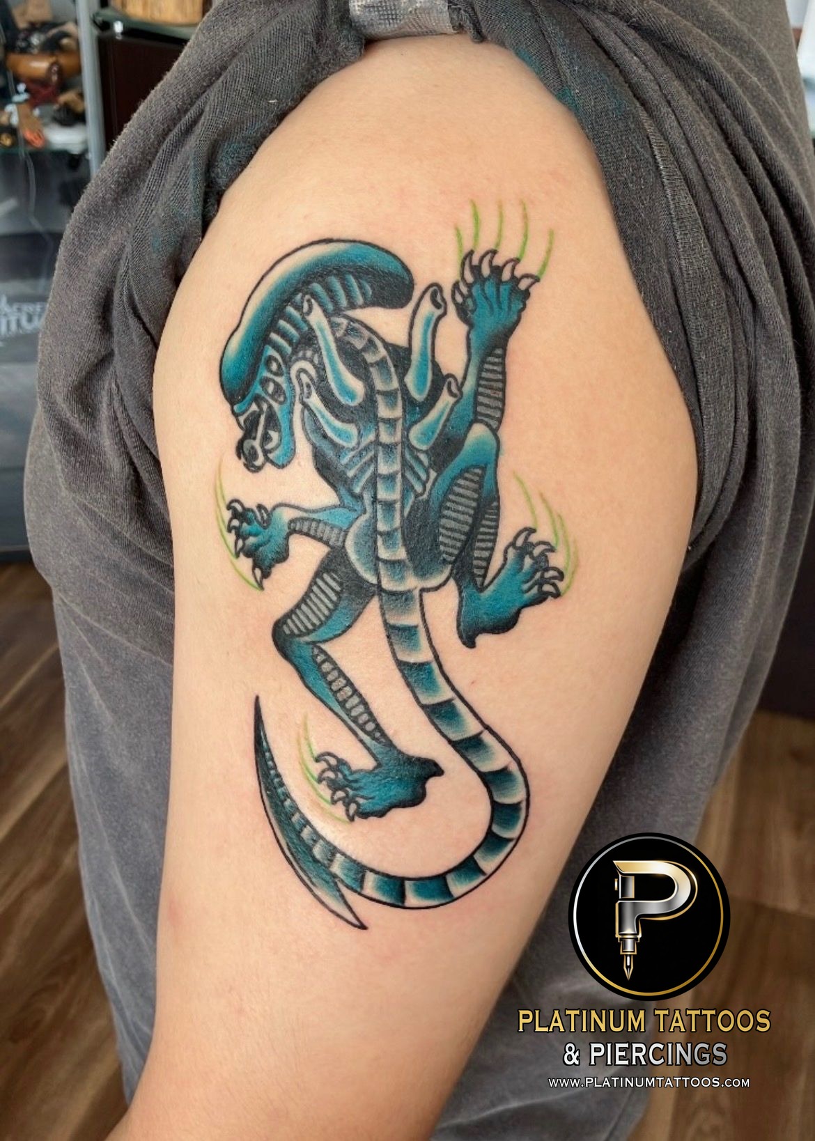 Black Xenomorph tattoo on the Outer Bicep by Jr at Platinum Tattoos & Piercings, San Antonio TX