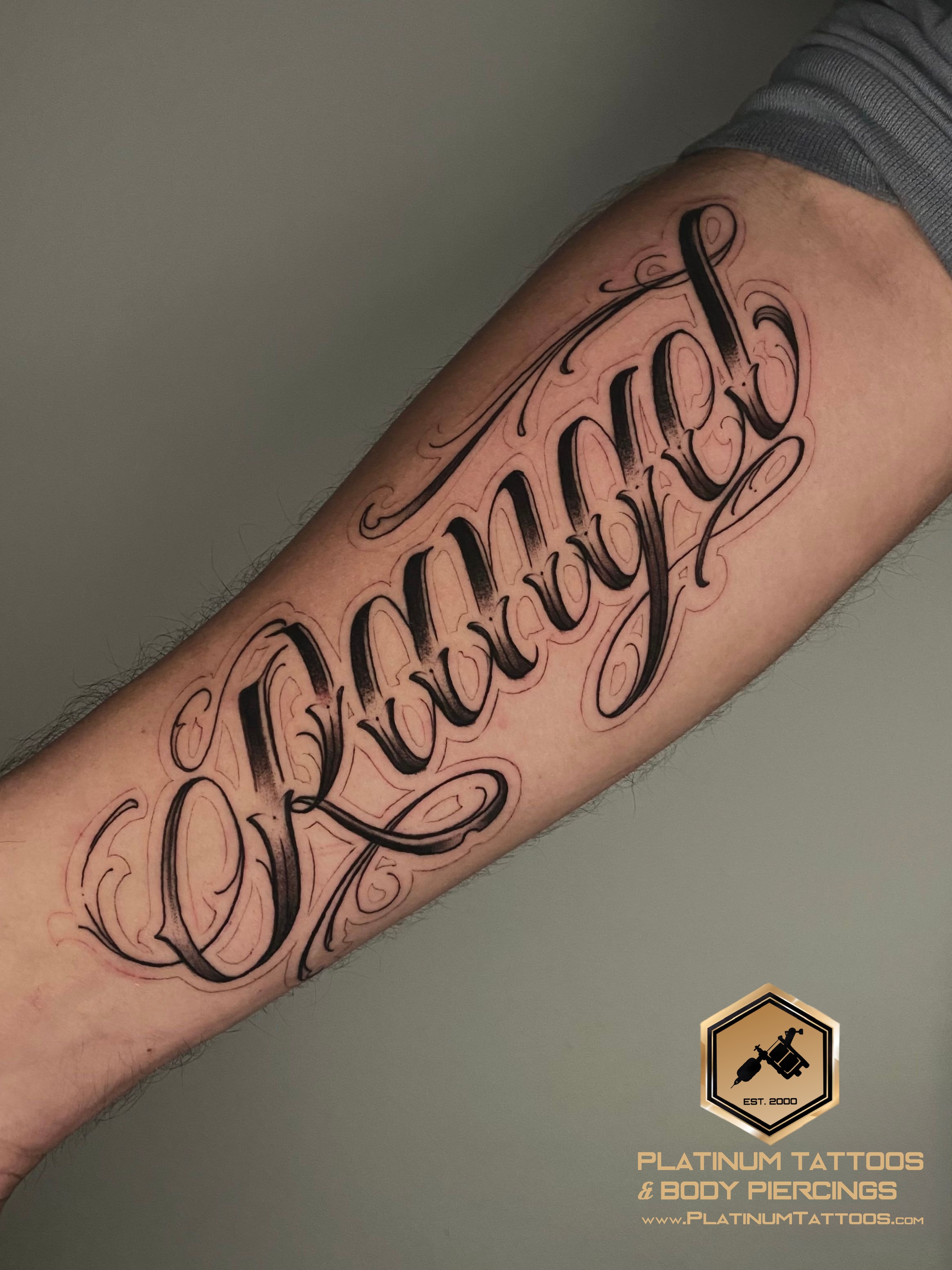 Lettering tattoo on the forearm by Remy at Platinum Tattoos & Piercings, San Antonio TX