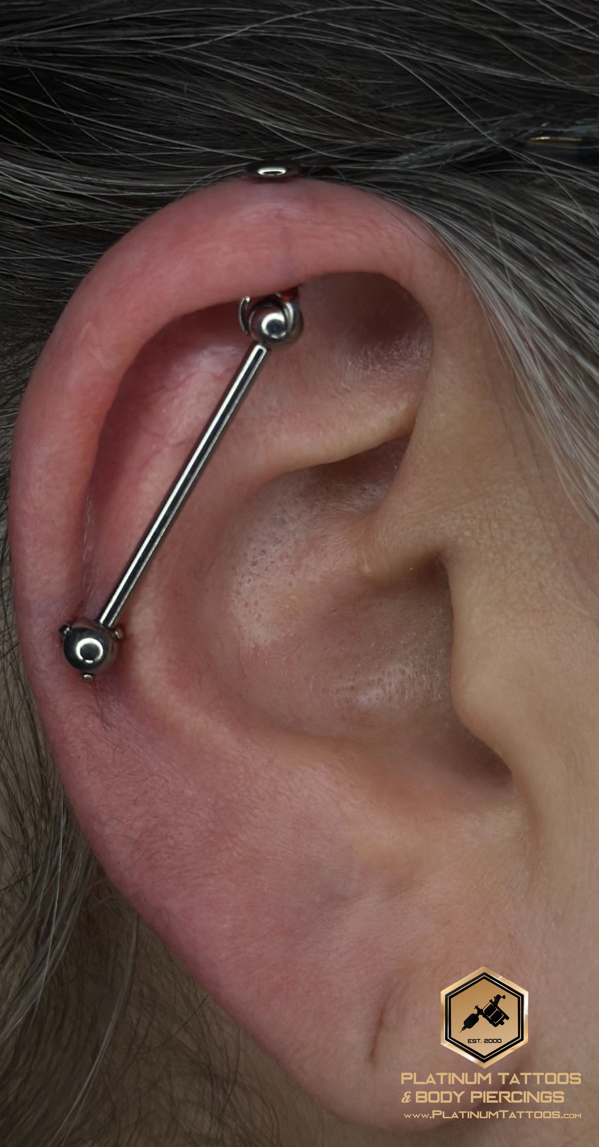 Piercing on the back by Noah at Platinum Tattoos & Piercings, San Antonio TX