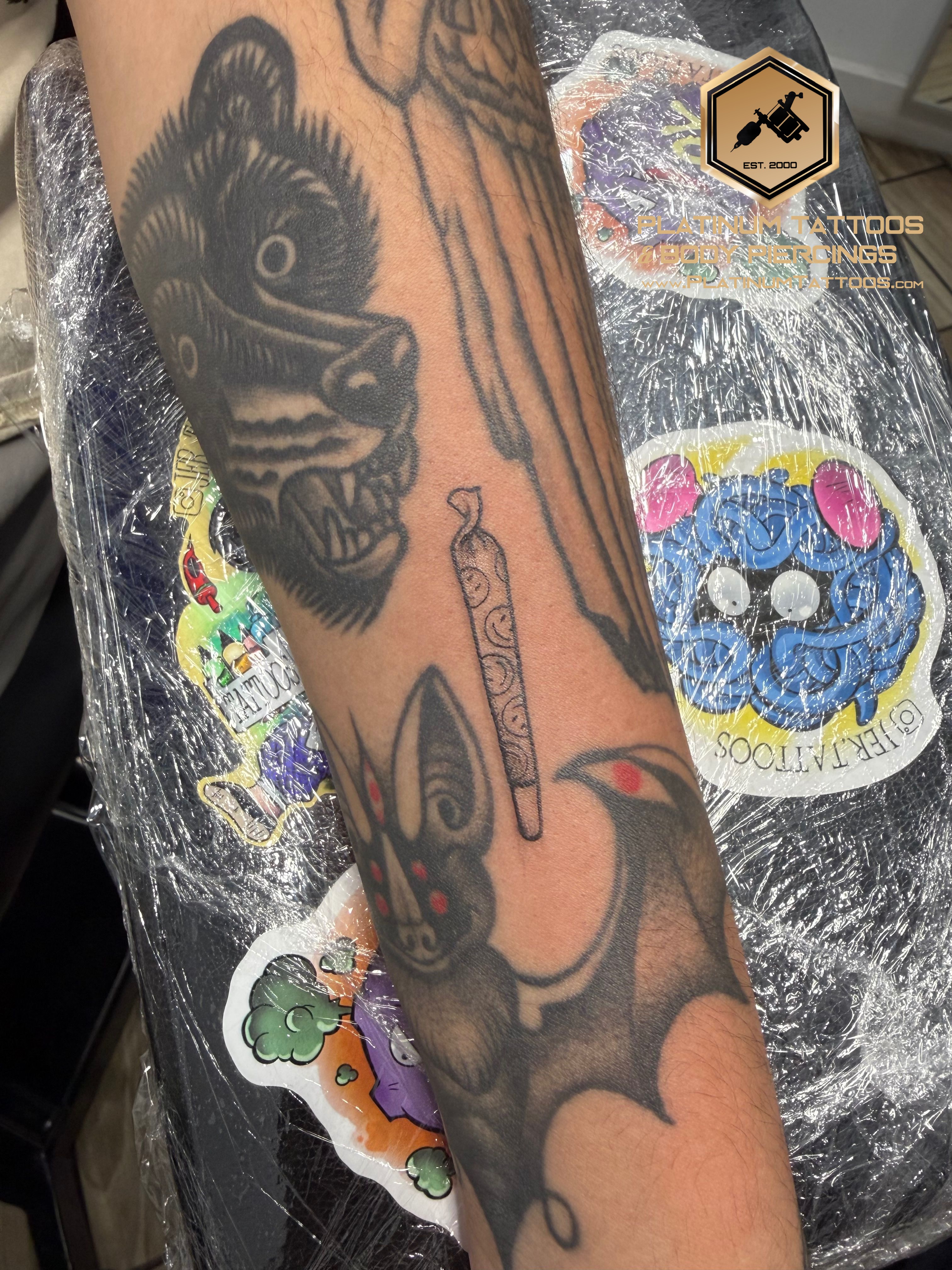 Fine Line Black Cigarro tattoo by Jerson at Platinum Tattoos & Piercings, San Antonio TX