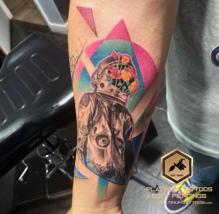Color, Black & Grey with Color, Abstract Black, White, Pink, Blue, Green, Grey, Multi-Color Flower, Astronaut tattoo on the Forearm at Platinum Tattoos & Piercings, San Antonio TX