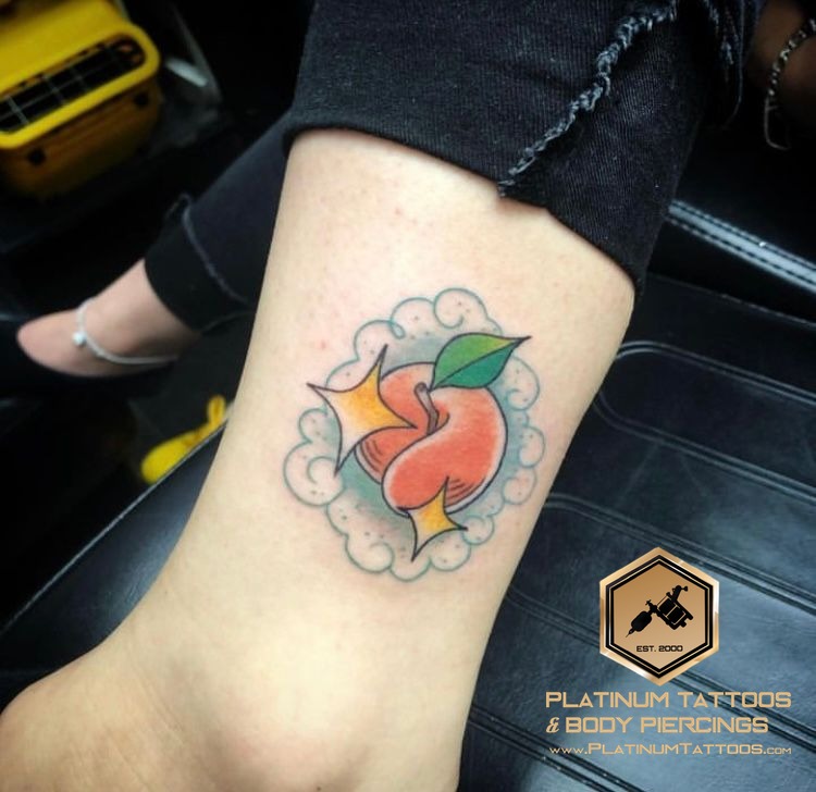 Color, Illustrative Orange, Green, Yellow, Blue Peach tattoo on the Ankle at Platinum Tattoos & Piercings, San Antonio TX