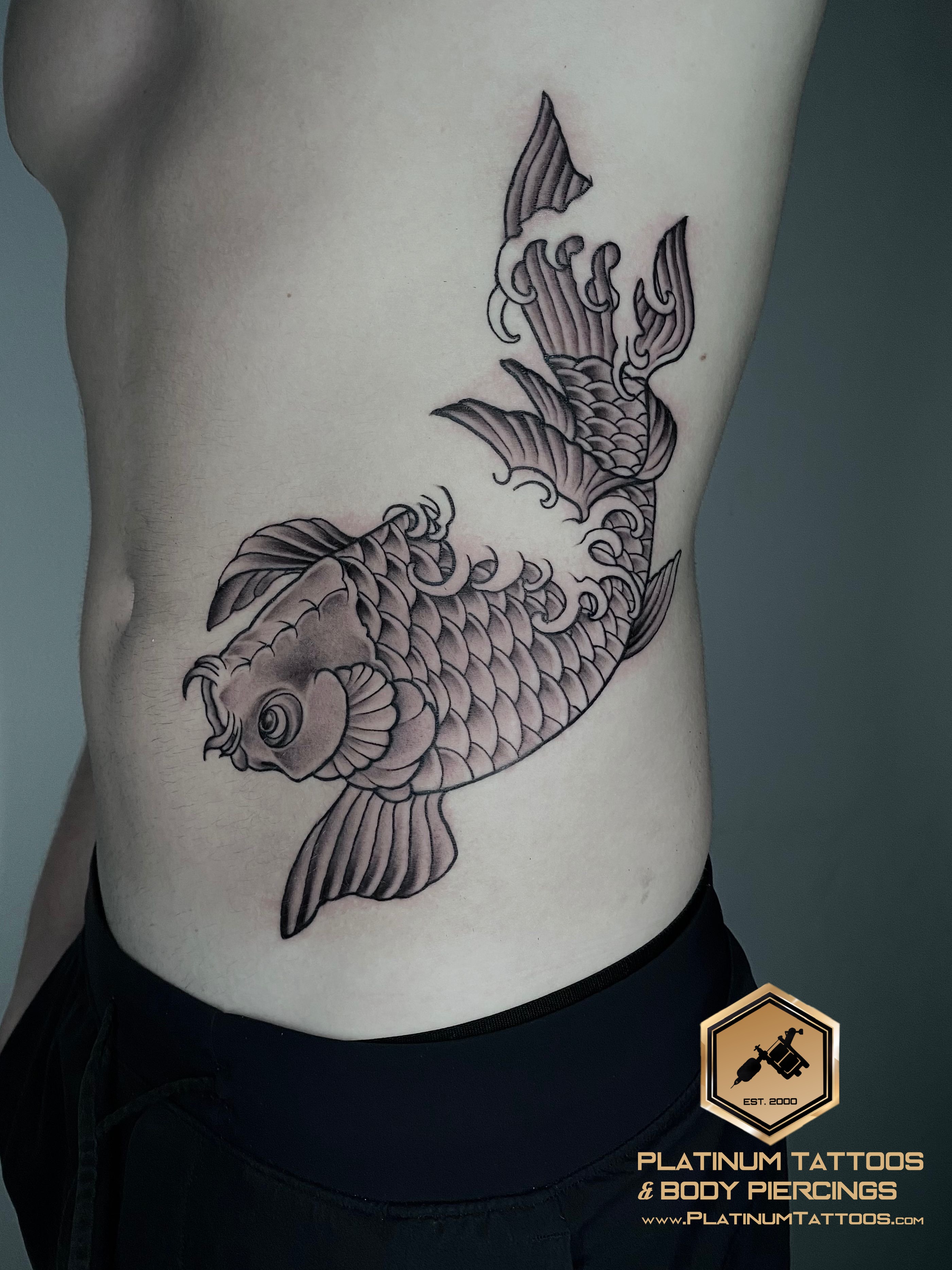 Japanese Black Fish tattoo on the Ribs by Remy at Platinum Tattoos & Piercings, San Antonio TX