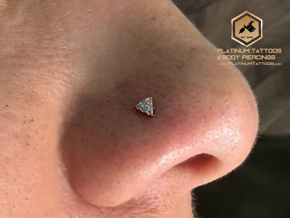 Nostril piercing with 14k Yellow Gold Threadless by Buddha Jewelry by Mingo at Platinum Tattoos & Piercings, San Antonio TX