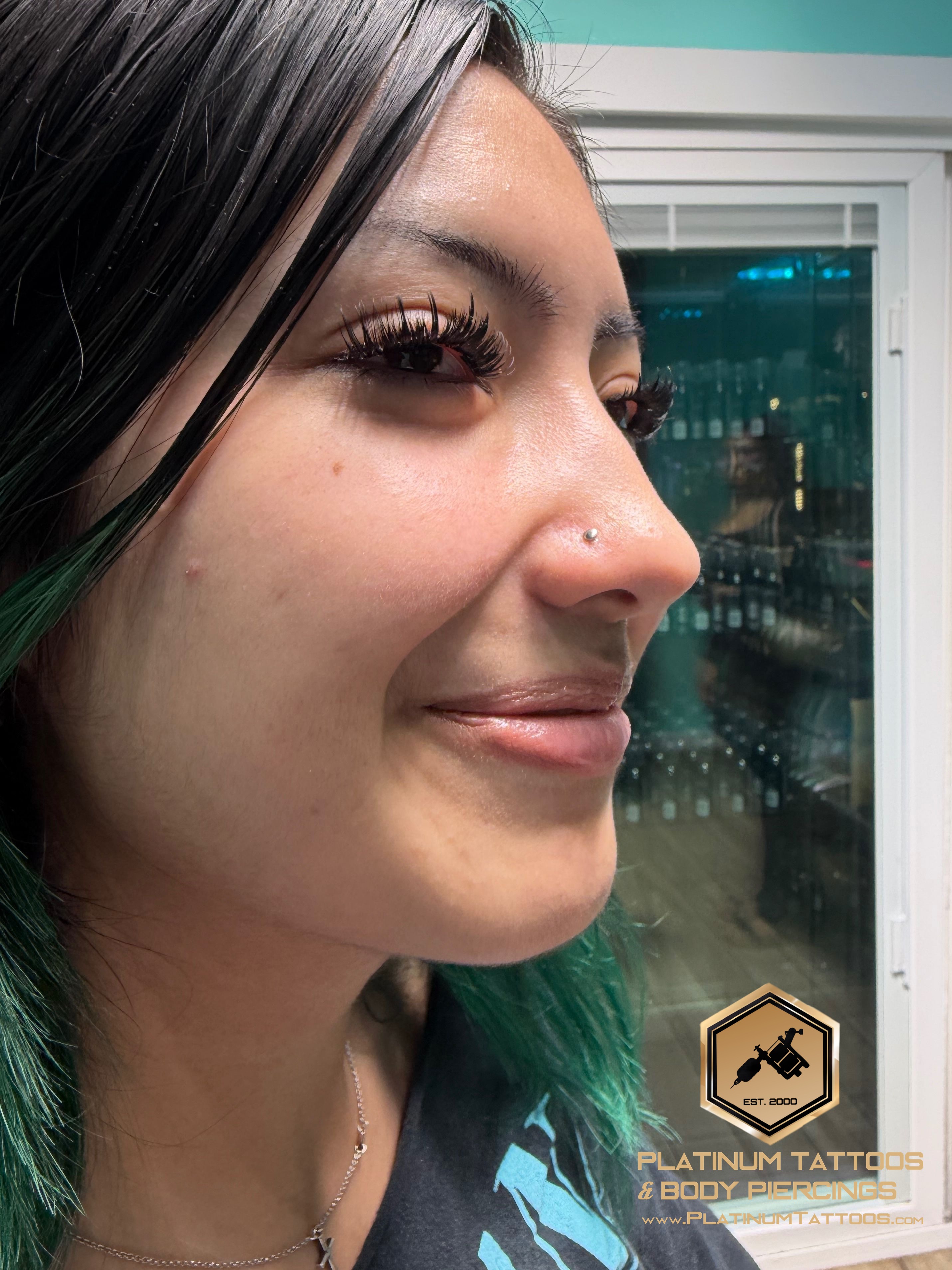 Nostril piercing with Implant Grade Titanium Disc by NeoMetal by Mingo at Platinum Tattoos & Piercings, San Antonio TX