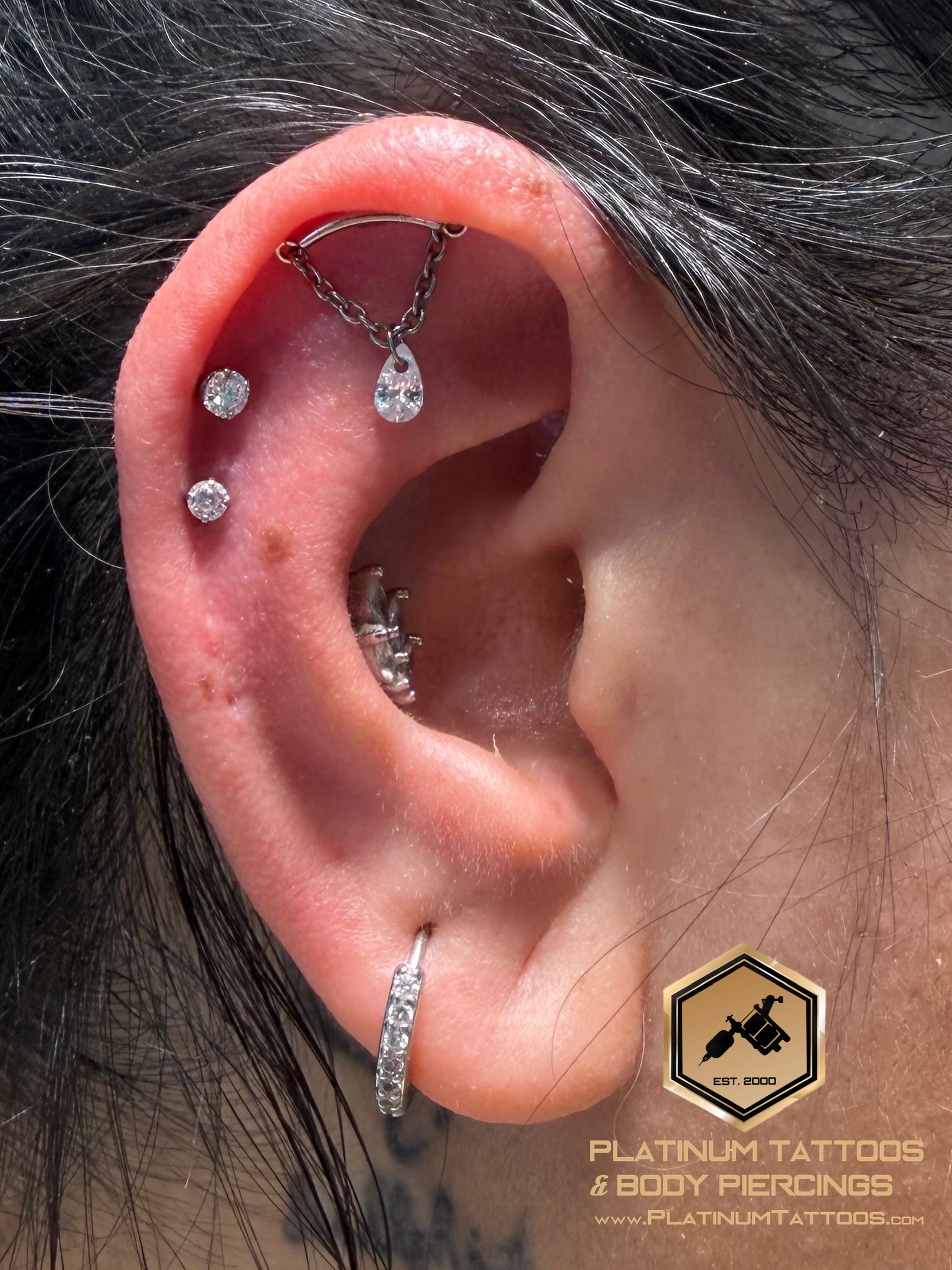 Curated ear piercing setup — Hidden Helix, 2nd Helix, 1st Helix with Implant Grade Titanium Dangle, Labret Stud/Flat Back by Tawapa, NeoMetal by Mingo at Platinum Tattoos & Body Piercings, San Antonio TX