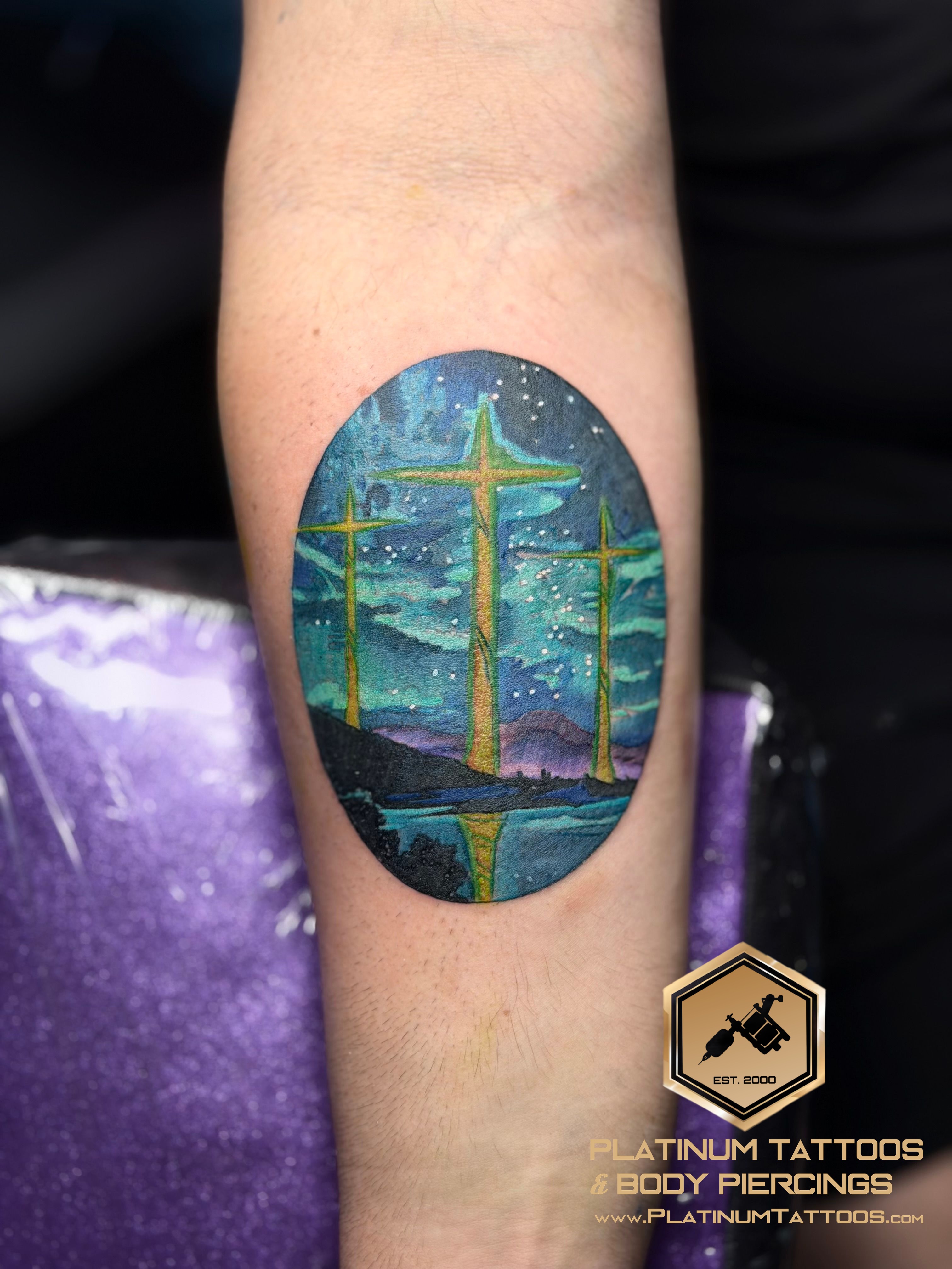 Color Blue, Purple, Green, Multi-Color Cross tattoo on the Forearm by Jr at Platinum Tattoos & Body Piercings, San Antonio TX