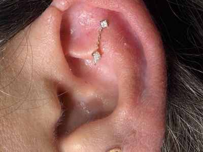 Flat piercing with 14k Yellow Gold Cluster/Multi-Gem by Mingo at Platinum Tattoos & Piercings, San Antonio TX