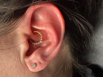 Conch piercing with Implant Grade Titanium Clicker by Other by Mingo at Platinum Tattoos & Piercings, San Antonio TX