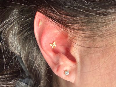 Conch piercing with 14k Yellow Gold Threadless by Mingo at Platinum Tattoos & Piercings, San Antonio TX