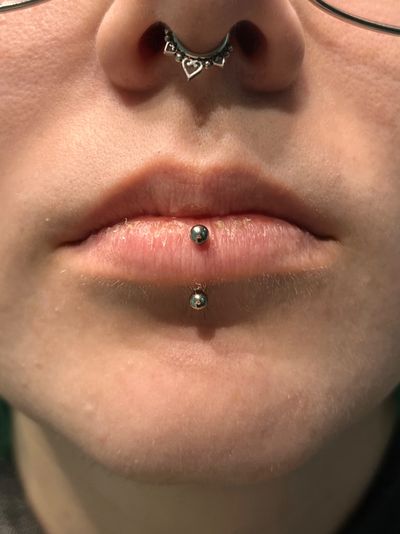 Vertical Labret piercing with Implant Grade Titanium Curved Barbell by Other by Harley at Platinum Tattoos & Piercings, San Antonio TX