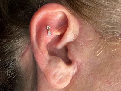 Flat piercing with 14k Yellow Gold Labret Stud/Flat Back by Other by Mingo at Platinum Tattoos & Piercings, San Antonio TX