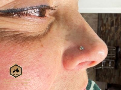 Nostril piercing with 14k White Gold Labret Stud/Flat Back by Other by Mingo at Platinum Tattoos & Piercings, San Antonio TX