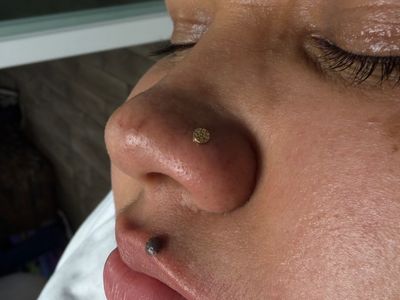 Nostril piercing with 14k Yellow Gold Labret Stud/Flat Back by Junipurr by Mingo at Platinum Tattoos & Piercings, San Antonio TX