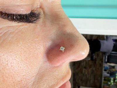 Nostril piercing with 18k Yellow Gold Labret Stud/Flat Back by Anatometal by Mingo at Platinum Tattoos & Piercings, San Antonio TX