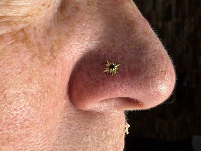 Nostril piercing with 14k Yellow Gold Labret Stud/Flat Back by Junipurr by Mingo at Platinum Tattoos & Body Piercings, San Antonio TX