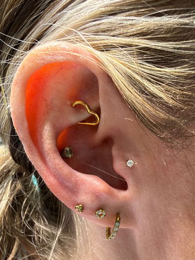 Tragus piercing with 18k Yellow Gold Labret Stud/Flat Back by Anatometal by Mingo at Platinum Tattoos & Body Piercings, San Antonio TX